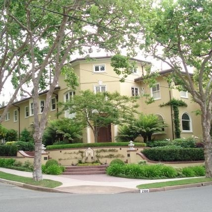 Julia Morgan-designed house in Piedmont behind mature street trees